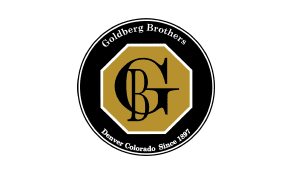 Logo of goldberg brothers featuring a stylized "gb" inside a black and gold hexagon with the text "denver colorado since 1897.