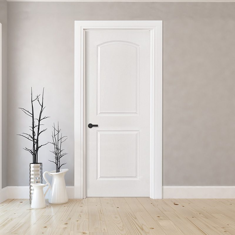 A white door in the middle of a room.