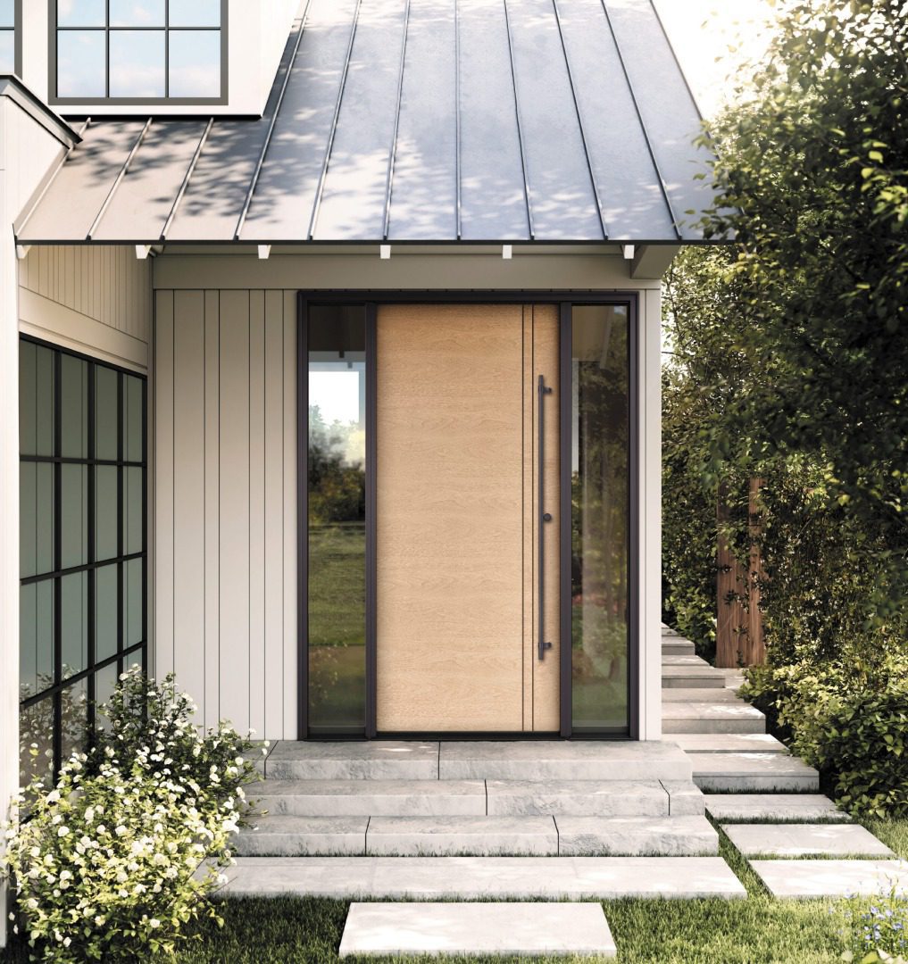 Modern house entrance featuring large glass doors with a beige curtain, flanked by white walls and surrounded by lush greenery.